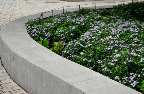 Concrete retaining wall with landscaped flowers